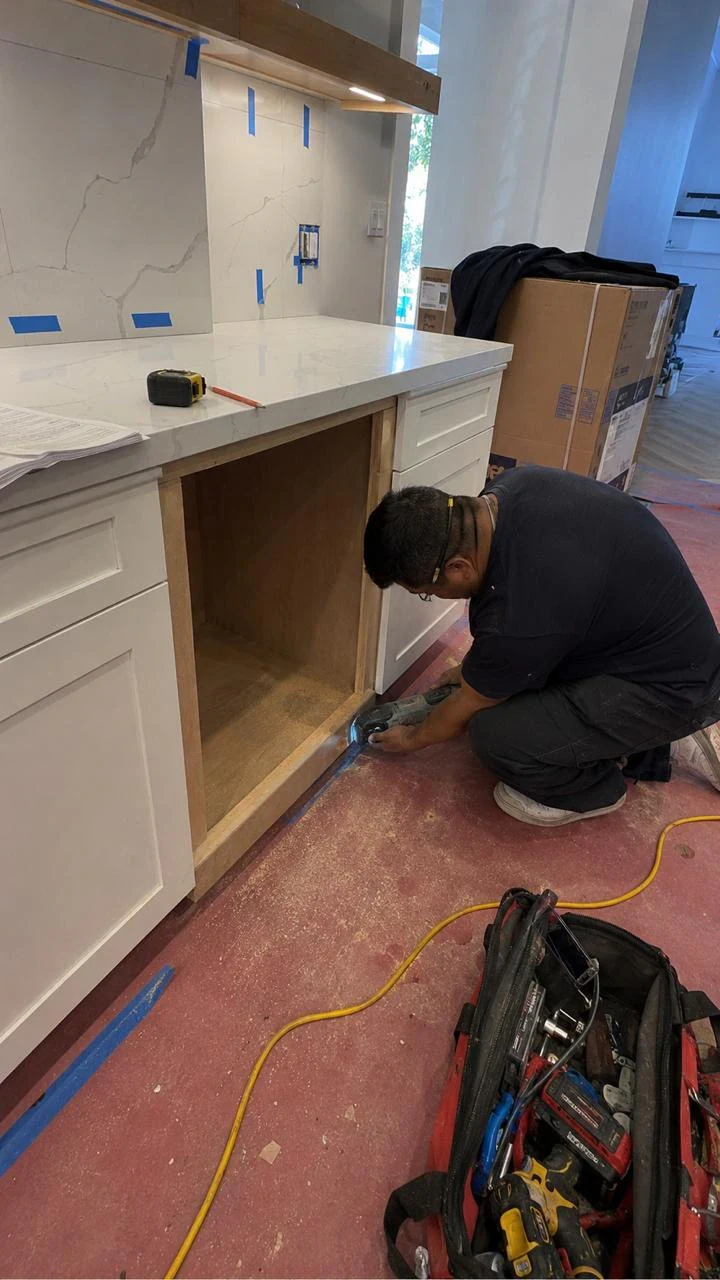Technician checking an appliance in a kitchen