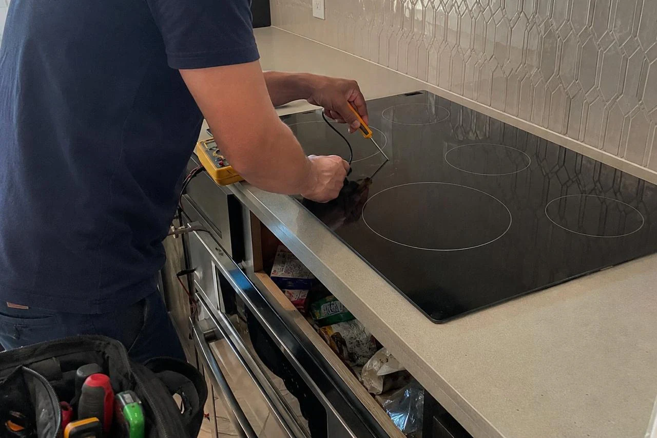 Cooktop Repair technician diagnosing a cooktop problem