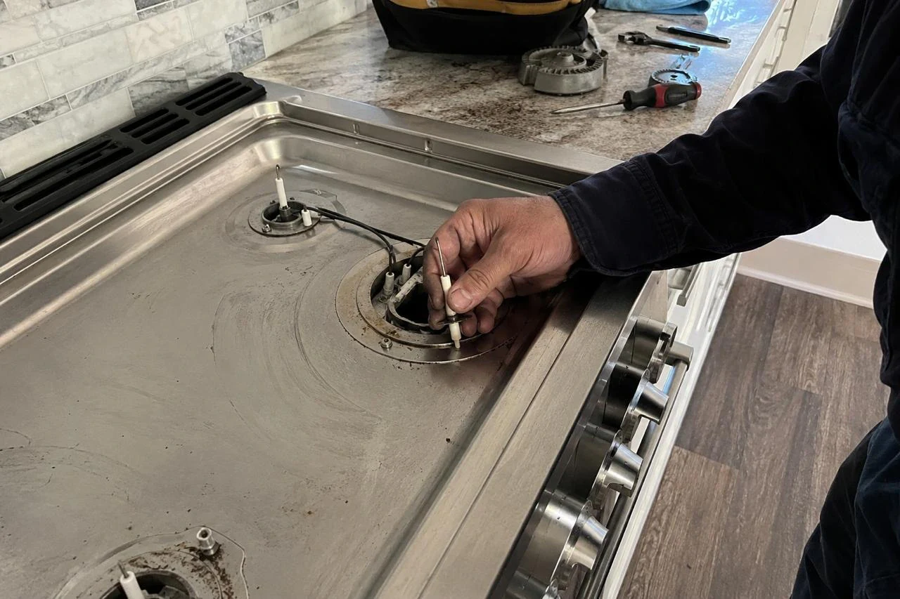 Stove Repair technician diagnosing a stove problem