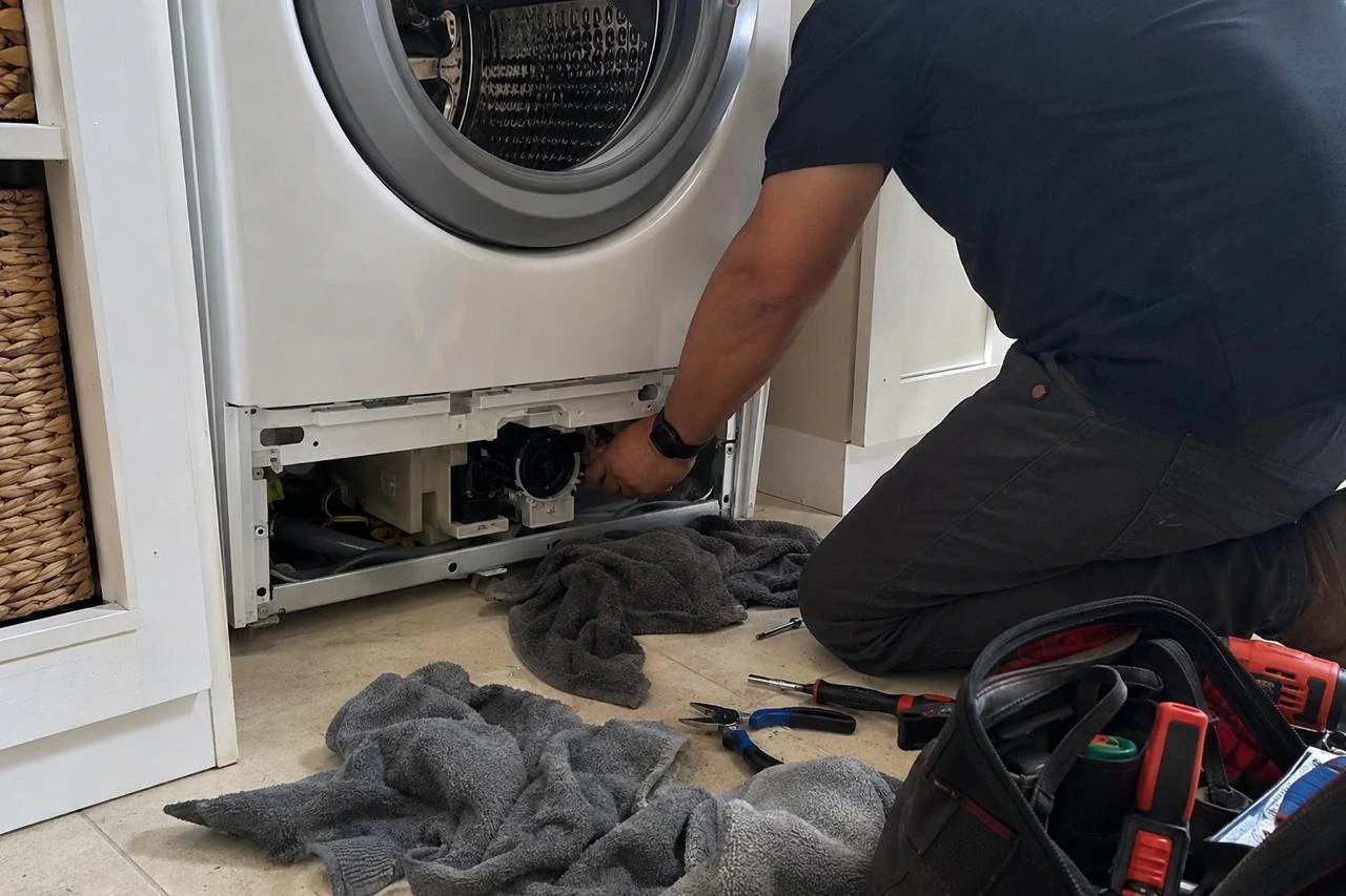 Washer Repair technician diagnosing a washer problem